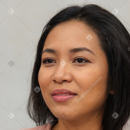 Joyful asian young-adult female with long  black hair and brown eyes