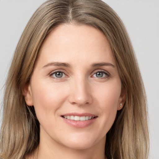 Joyful white young-adult female with long  brown hair and grey eyes