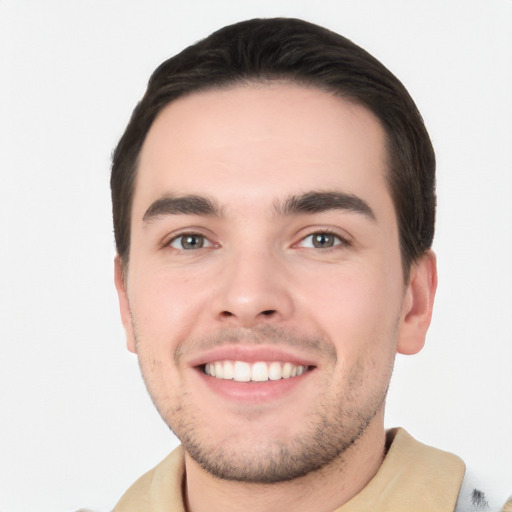 Joyful white young-adult male with short  black hair and brown eyes