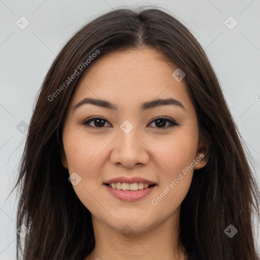 Joyful latino young-adult female with long  brown hair and brown eyes