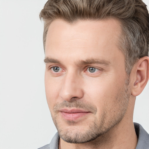 Joyful white adult male with short  brown hair and brown eyes