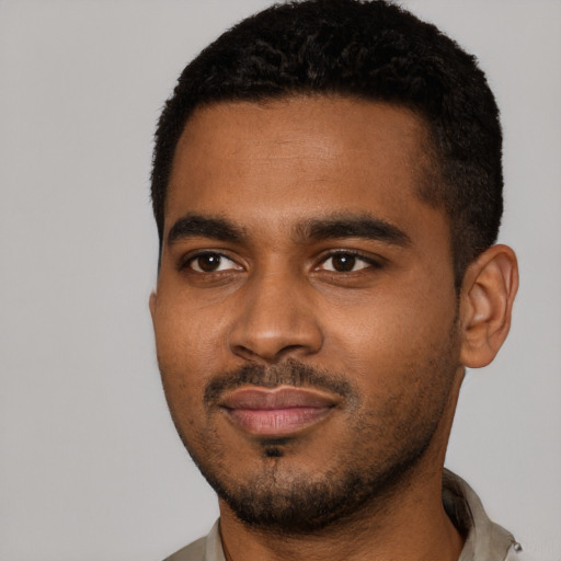 Joyful black young-adult male with short  black hair and brown eyes
