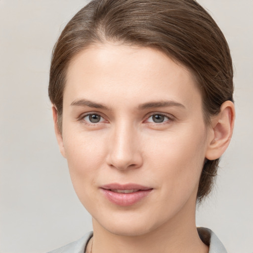 Joyful white young-adult female with medium  brown hair and grey eyes