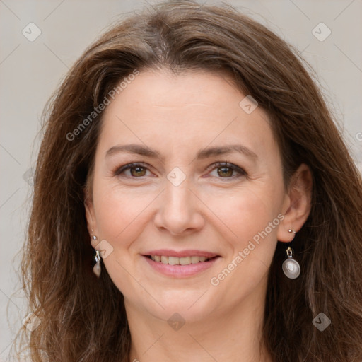 Joyful white adult female with long  brown hair and grey eyes