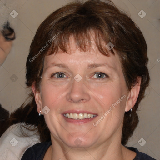 Joyful white adult female with medium  brown hair and blue eyes