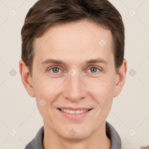 Joyful white adult male with short  brown hair and grey eyes