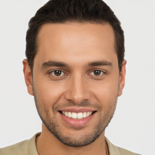 Joyful white young-adult male with short  brown hair and brown eyes