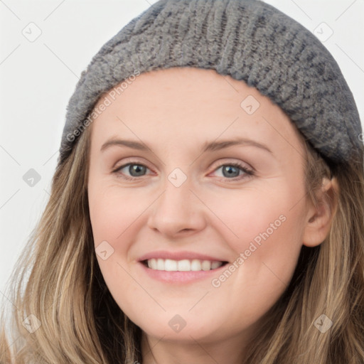 Joyful white young-adult female with long  brown hair and blue eyes