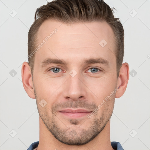 Joyful white young-adult male with short  brown hair and grey eyes