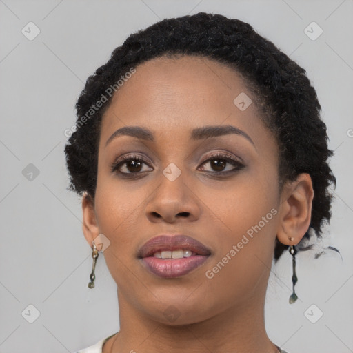 Joyful black young-adult female with short  black hair and brown eyes