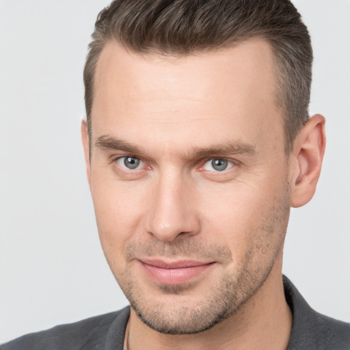 Joyful white young-adult male with short  brown hair and brown eyes