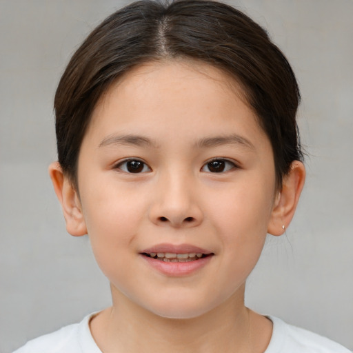 Joyful white child female with short  brown hair and brown eyes