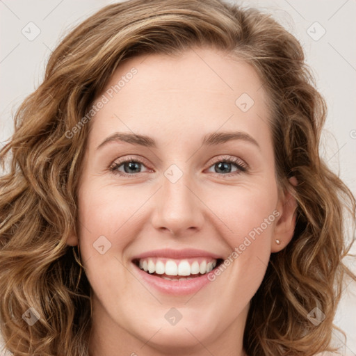 Joyful white young-adult female with long  brown hair and green eyes