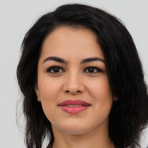 Joyful latino young-adult female with long  black hair and brown eyes
