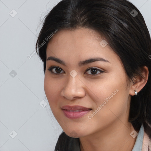 Joyful asian young-adult female with long  brown hair and brown eyes