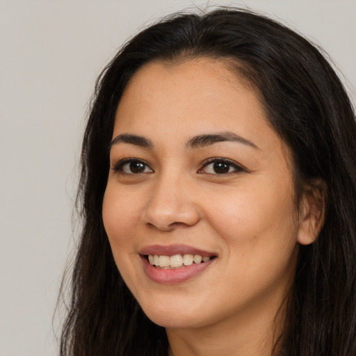 Joyful asian young-adult female with long  brown hair and brown eyes