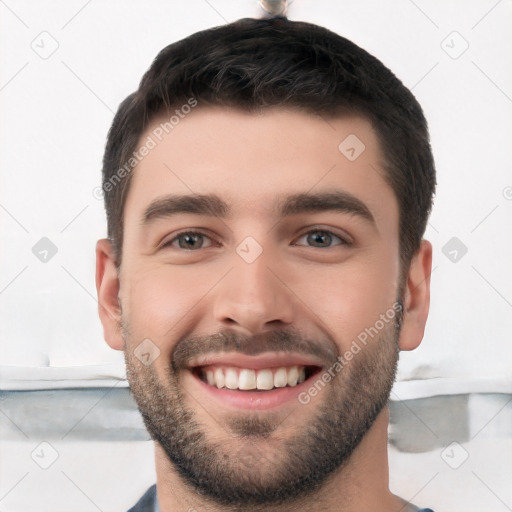 Joyful white young-adult male with short  black hair and brown eyes