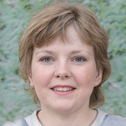 Joyful white young-adult female with medium  brown hair and blue eyes