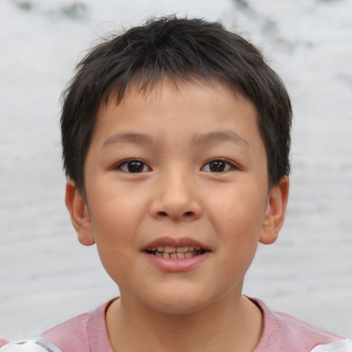 Joyful asian child male with short  brown hair and brown eyes