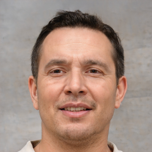 Joyful white adult male with short  brown hair and brown eyes