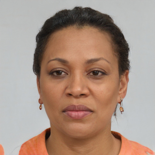 Joyful latino adult female with short  brown hair and brown eyes