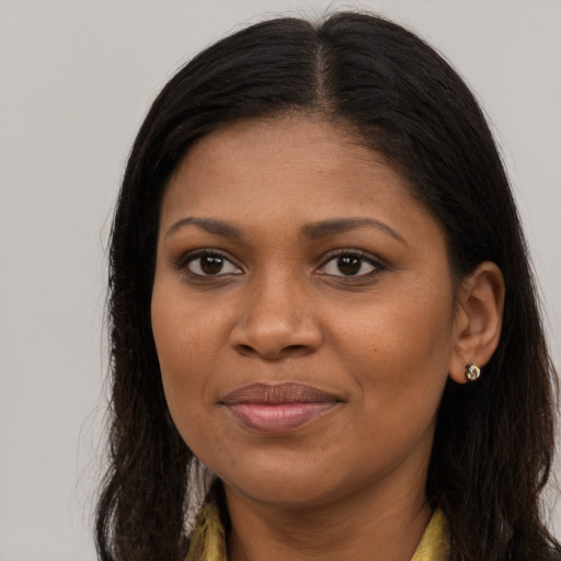 Joyful black young-adult female with long  brown hair and brown eyes