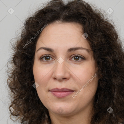 Joyful white adult female with long  brown hair and brown eyes