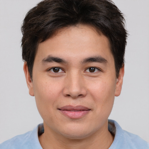 Joyful asian young-adult male with short  brown hair and brown eyes