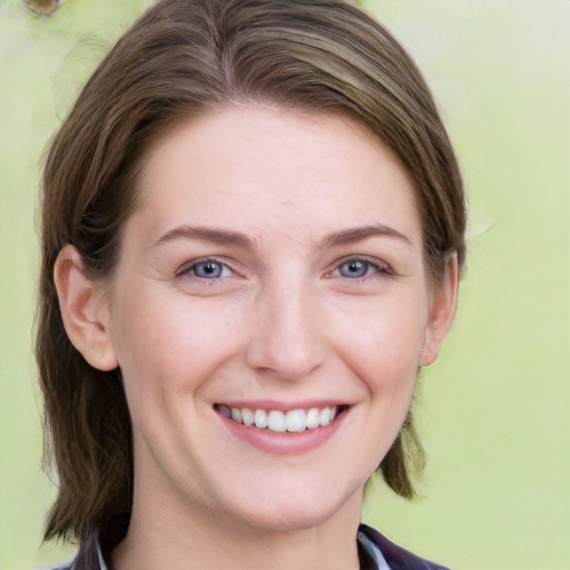 Joyful white young-adult female with long  brown hair and blue eyes