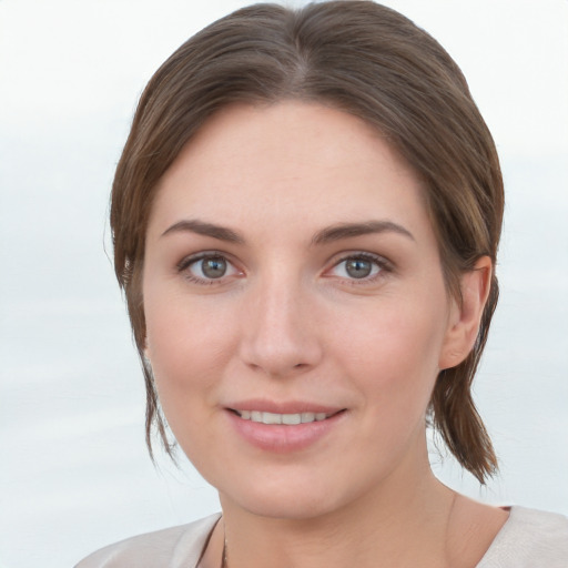 Joyful white young-adult female with medium  brown hair and grey eyes