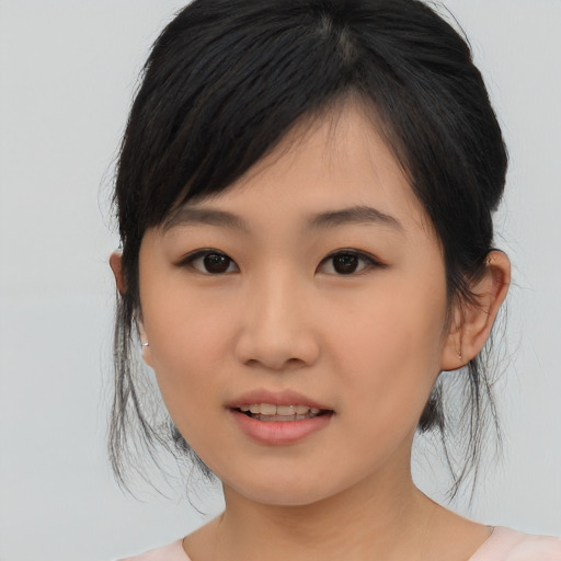 Joyful asian young-adult female with medium  black hair and brown eyes