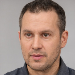 Joyful white adult male with short  brown hair and brown eyes