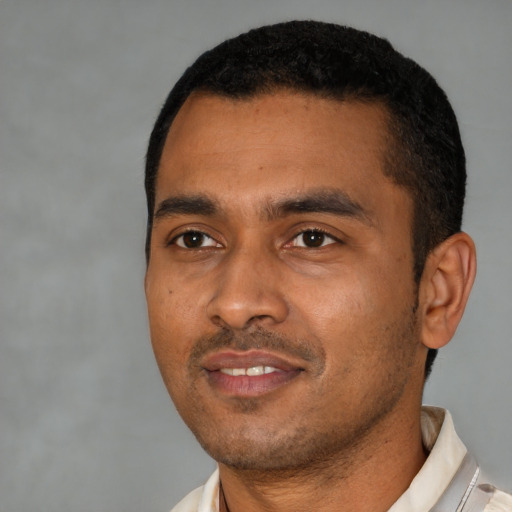 Joyful latino young-adult male with short  black hair and brown eyes