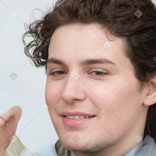 Joyful white young-adult male with medium  brown hair and brown eyes