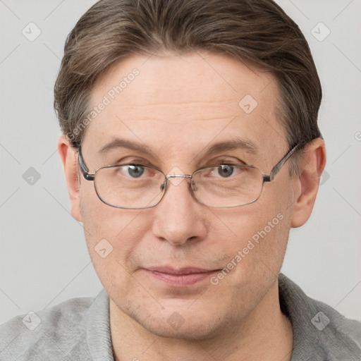 Joyful white adult male with short  brown hair and grey eyes