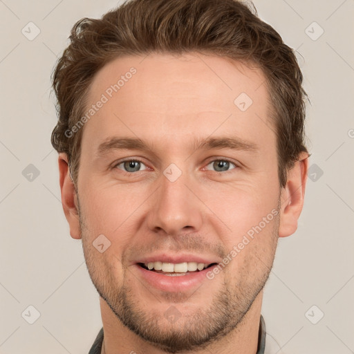 Joyful white young-adult male with short  brown hair and grey eyes