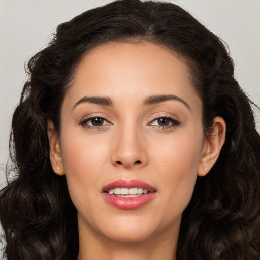 Joyful white young-adult female with long  brown hair and brown eyes