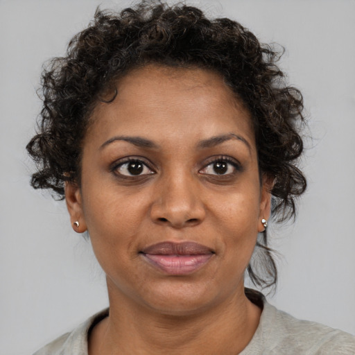Joyful black adult female with short  brown hair and brown eyes