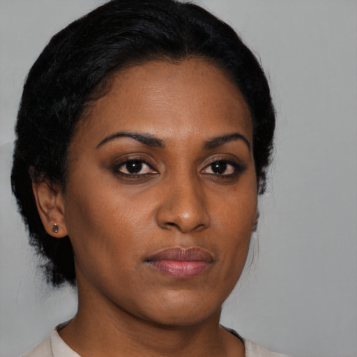 Joyful black young-adult female with medium  brown hair and brown eyes