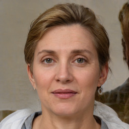 Joyful white adult female with medium  brown hair and grey eyes