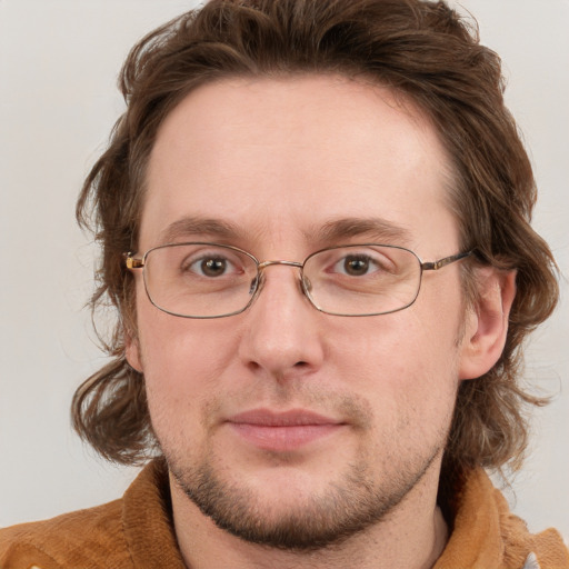 Joyful white adult male with medium  brown hair and grey eyes