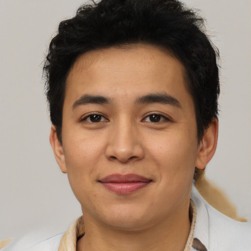 Joyful latino young-adult male with short  brown hair and brown eyes