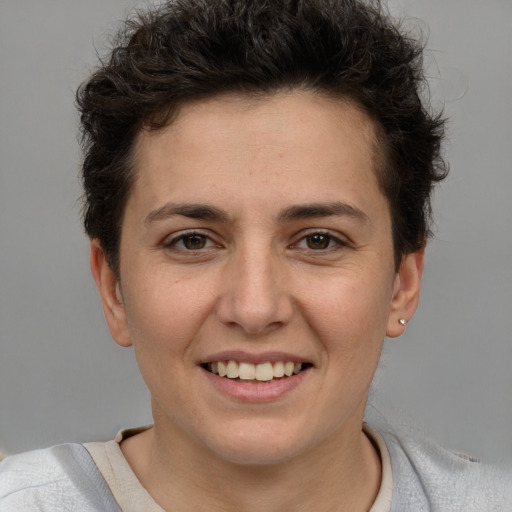 Joyful white young-adult female with short  brown hair and grey eyes