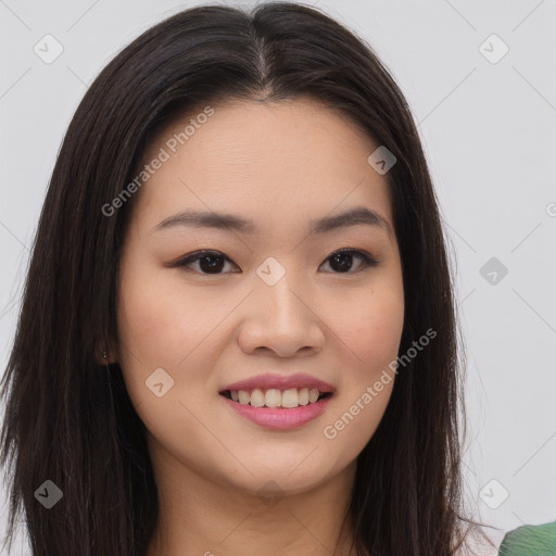 Joyful asian young-adult female with long  brown hair and brown eyes