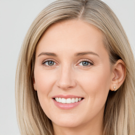 Joyful white young-adult female with long  brown hair and blue eyes