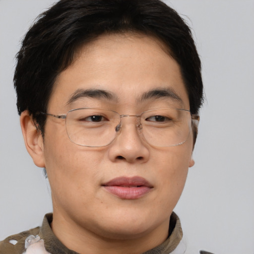Joyful asian adult male with short  brown hair and brown eyes