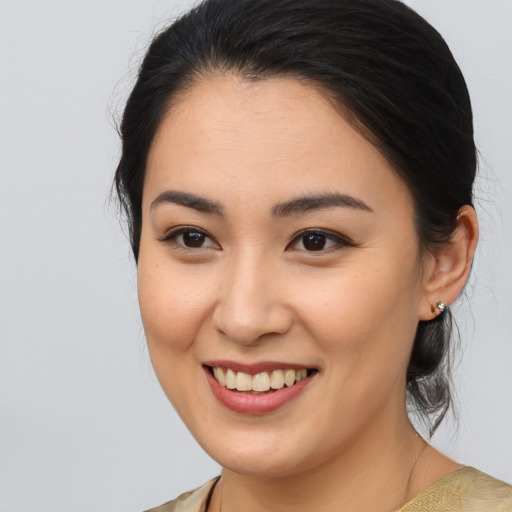 Joyful asian young-adult female with medium  brown hair and brown eyes