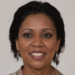 Joyful black adult female with medium  brown hair and brown eyes
