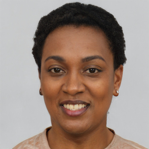 Joyful black young-adult female with short  black hair and brown eyes