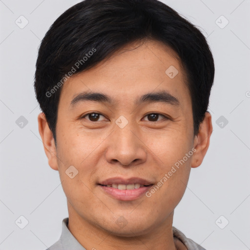 Joyful asian young-adult male with short  black hair and brown eyes